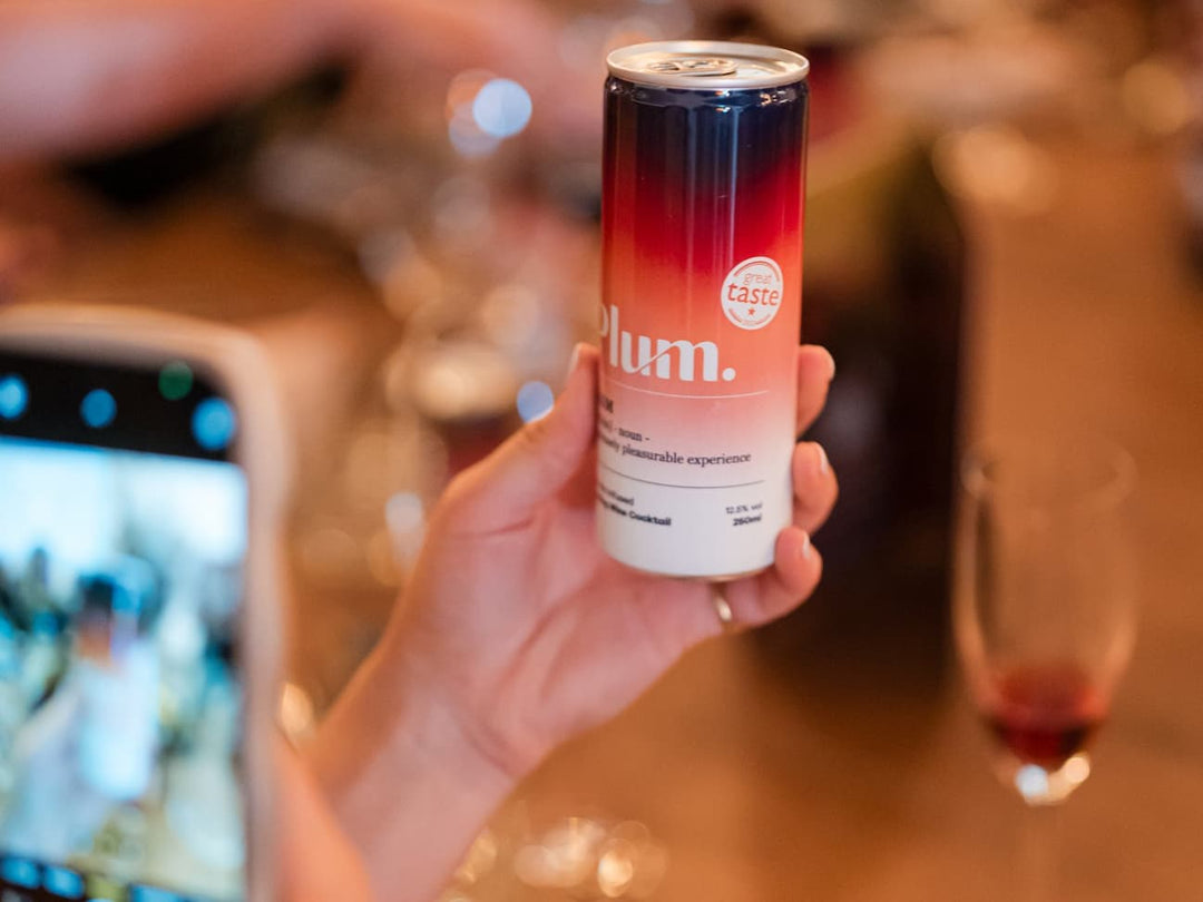 A PlumGasm can held up at a candlelit Christmas dinner table