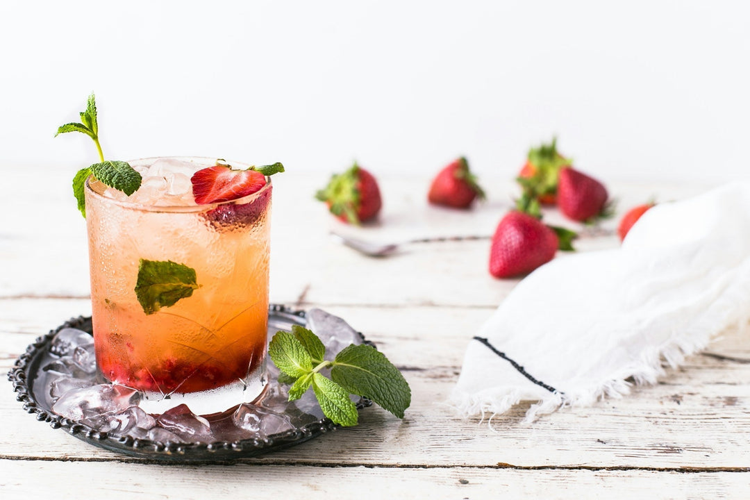 a garnished spring cocktail on a wooden table